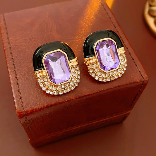 Black enamel stud earrings with amethyst-tone crystal and rhinestone frame — Midnight Amethyst Radiance Earrings.