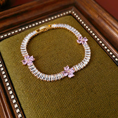 Petal Sparkle Tennis Bracelet lineup in gold and silver with pink and blue accents – baguette zircon floral design
