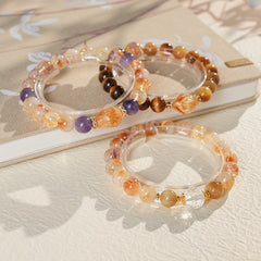 Sunset Harmony Crystal Bangle with yellow crystal and tiger-eye beads, gold-tone spacers, and a clear ring core.