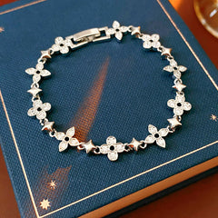Radiant Flora Bracelet with zircon-studded floral and star motifs on dark blue box – Glazenya jewelry