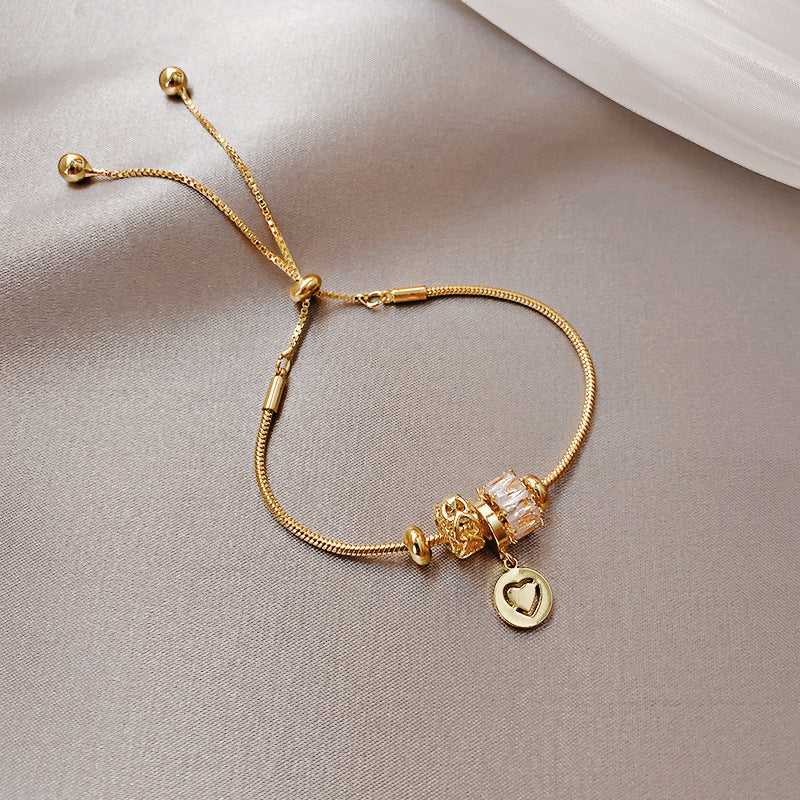 Gold-plated bracelet collection with pearls, cat’s eye stones, and floral motifs