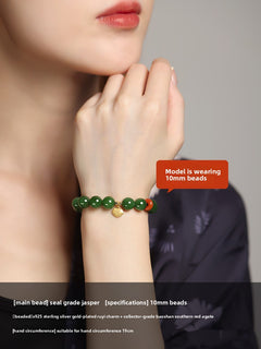 Green Hetian (nephrite) jade bead bracelet with red spacer and gold-tone charm