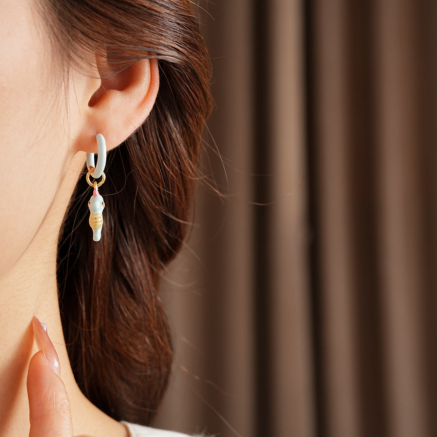 Pastel enamel huggie earrings with mismatched seahorse and striped fish charms — Seafoam Mismatch Ocean Charm Huggies.