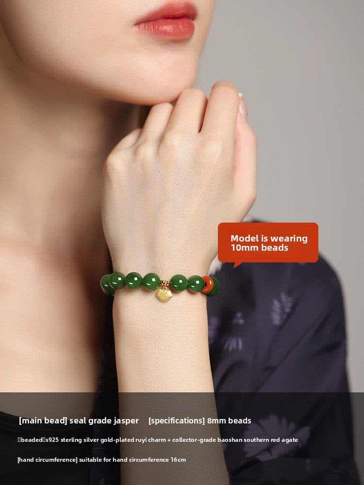 Green Hetian (nephrite) jade bead bracelet with red spacer and gold-tone charm