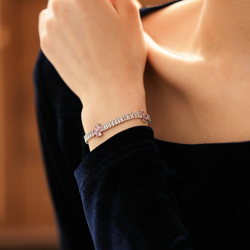 Petal Sparkle Tennis Bracelet lineup in gold and silver with pink and blue accents – baguette zircon floral design