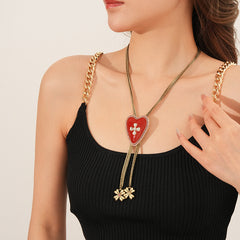 Lariat necklace with beaded-edge heart pendant and twin tassel blossoms on model — Regal Heart Tassel Lariat Necklace.