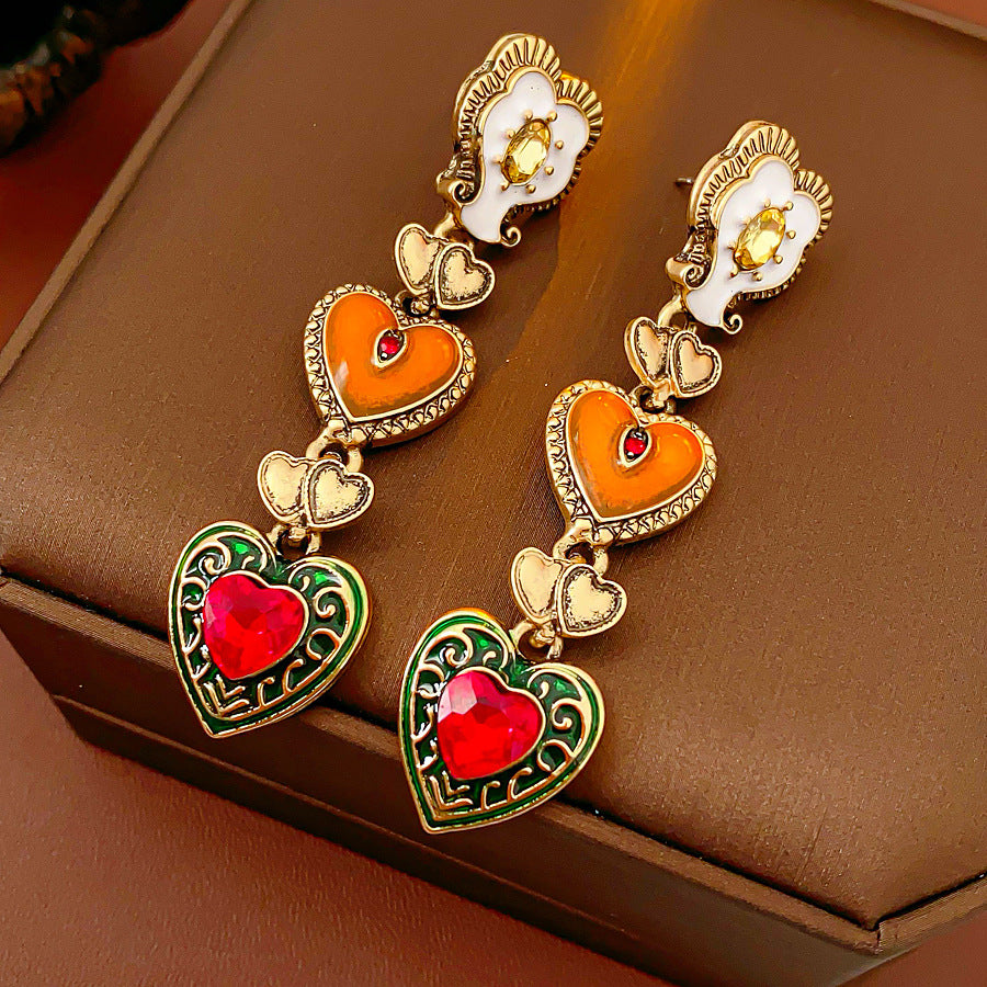 Enchanted Love Drop Earrings – vintage baroque heart-shaped dangle design with gold alloy and red crystal accents, 7cm length jewelry display