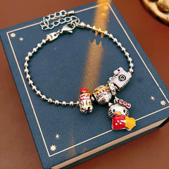 Kawaii Charm Story Bracelet with cartoon cat, burger, camera, and bell charms on silver-tone bead chain