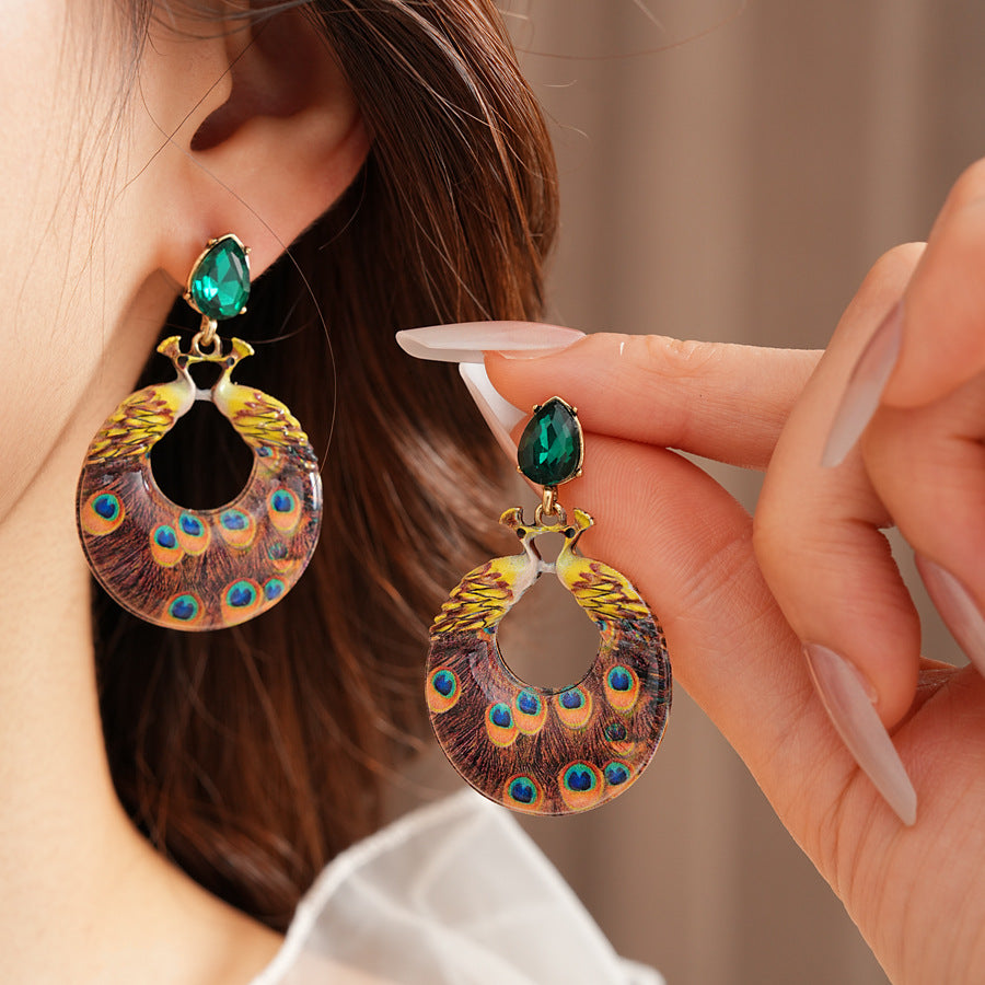 Statement earrings with peacock feather hoop design and emerald stud – Peacock Glory Statement Earrings.