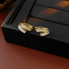 Gold huggie hoop earrings with ivory enamel arc and baguette CZ row — Luna Arc Enamel Baguette Huggies.