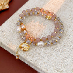 Celestial Cat’s Eye Bracelet double strand with cat’s-eye stones, freshwater pearls, crystal beads and gold planet charm