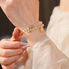 Double-layer dopamine crystal bracelet with clear crystals and colorful stone beads on green velvet background