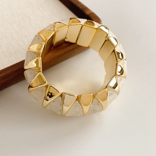 Gold-tone segmented bangle with marbled acrylic dome tiles — Gilded Capsule Resin Bangle.