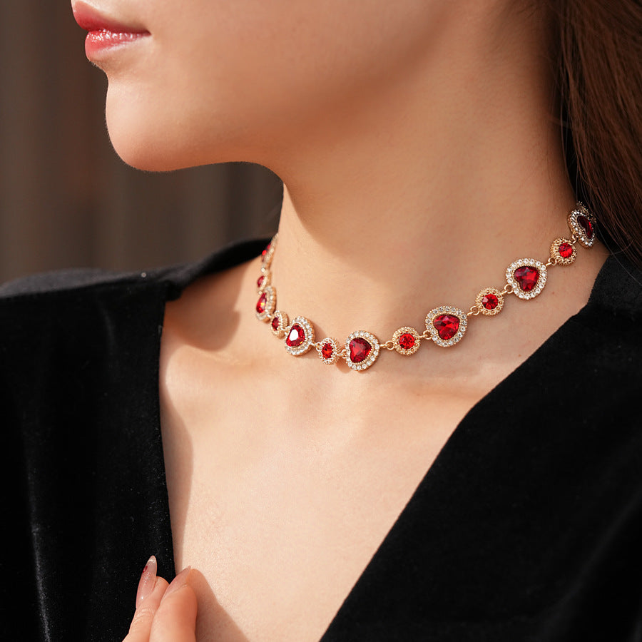 Crimson Heart Luxe Collection with red heart gemstone necklace, bracelet, and earrings, accented with pavé details