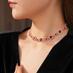 Crimson Heart Luxe Collection with red heart gemstone necklace, bracelet, and earrings, accented with pavé details