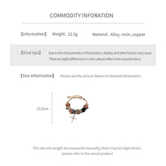Leopard Cross Luxe Bracelet with leopard-patterned beads, zircon accents, black 8-ball bead, and cross pendant on gold chain