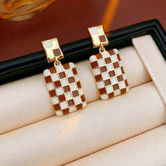 Gilded Mosaic Drop Earrings in two colors — geometric enamel checker tiles with gold-plated frame, Midnight Blue and Mocha Ivory, silver post dangle design on jewelry tray