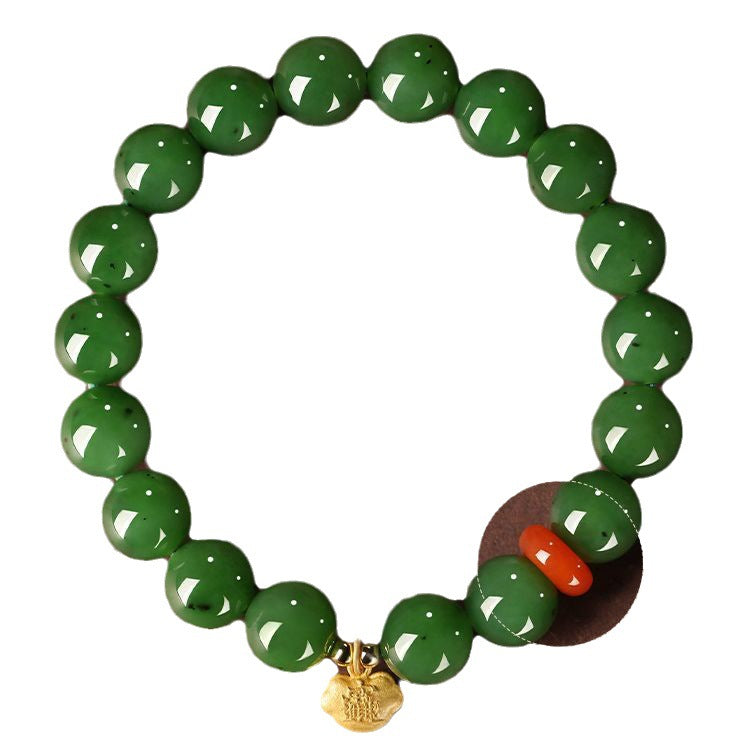 Green Hetian (nephrite) jade bead bracelet with red spacer and gold-tone charm