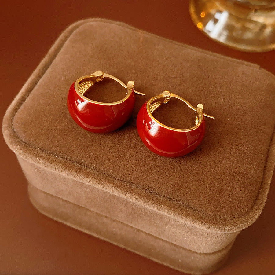 Cherry-red enamel dome huggie hoop earrings with gold tone finish — Cherry Lacquer Dome Huggies.