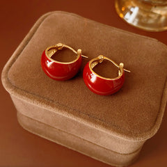 Cherry-red enamel dome huggie hoop earrings with gold tone finish — Cherry Lacquer Dome Huggies.