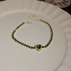 Gold-plated bracelet collection with pearls, cat’s eye stones, and floral motifs