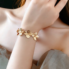 Golden Petal Elegance Set with necklace, bracelet, and earrings featuring golden floral petal details