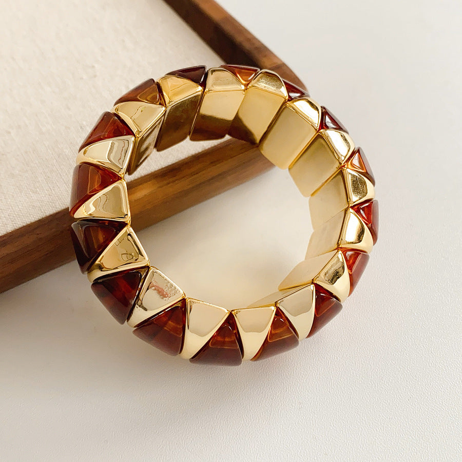 Gold-tone segmented bangle with marbled acrylic dome tiles — Gilded Capsule Resin Bangle.