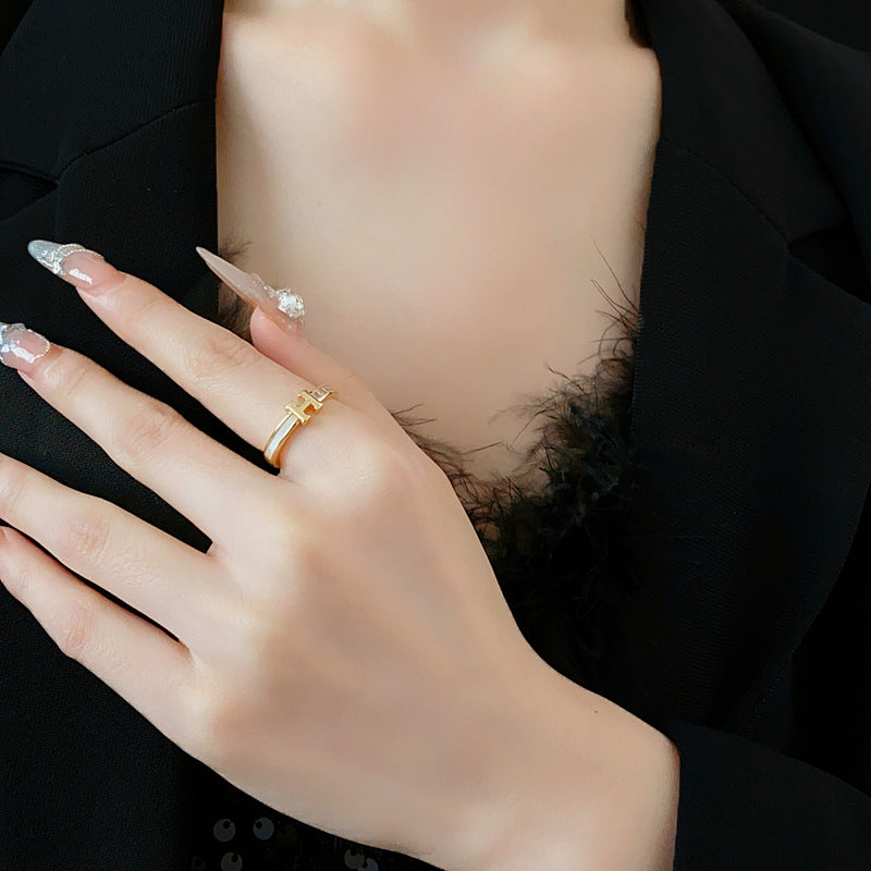 Gold-tone open ring with initial bridge and channel-set pavé cubic zirconia — Lumière Initial Pavé Open Ring.