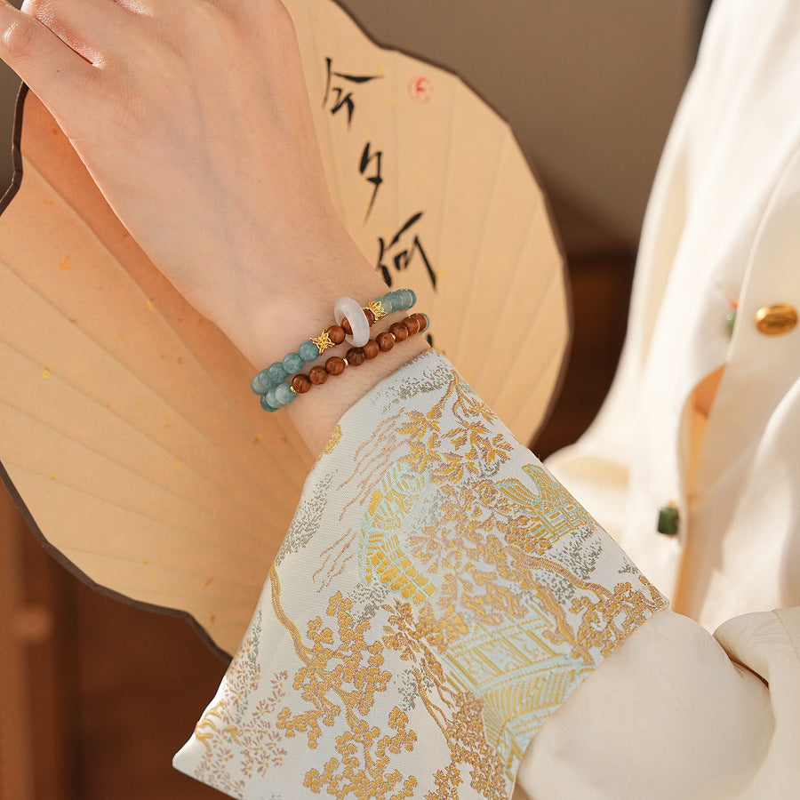 A double-wrap bracelet of sea blue and brown chalcedony beads, embellished with white rings - Dual-Tone Chalcedony Double-Wrap Bracelet.