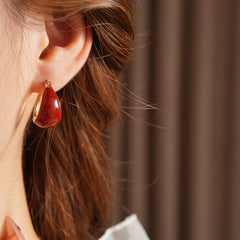 Cherry-red enamel dome huggie hoop earrings with gold tone finish — Cherry Lacquer Dome Huggies.