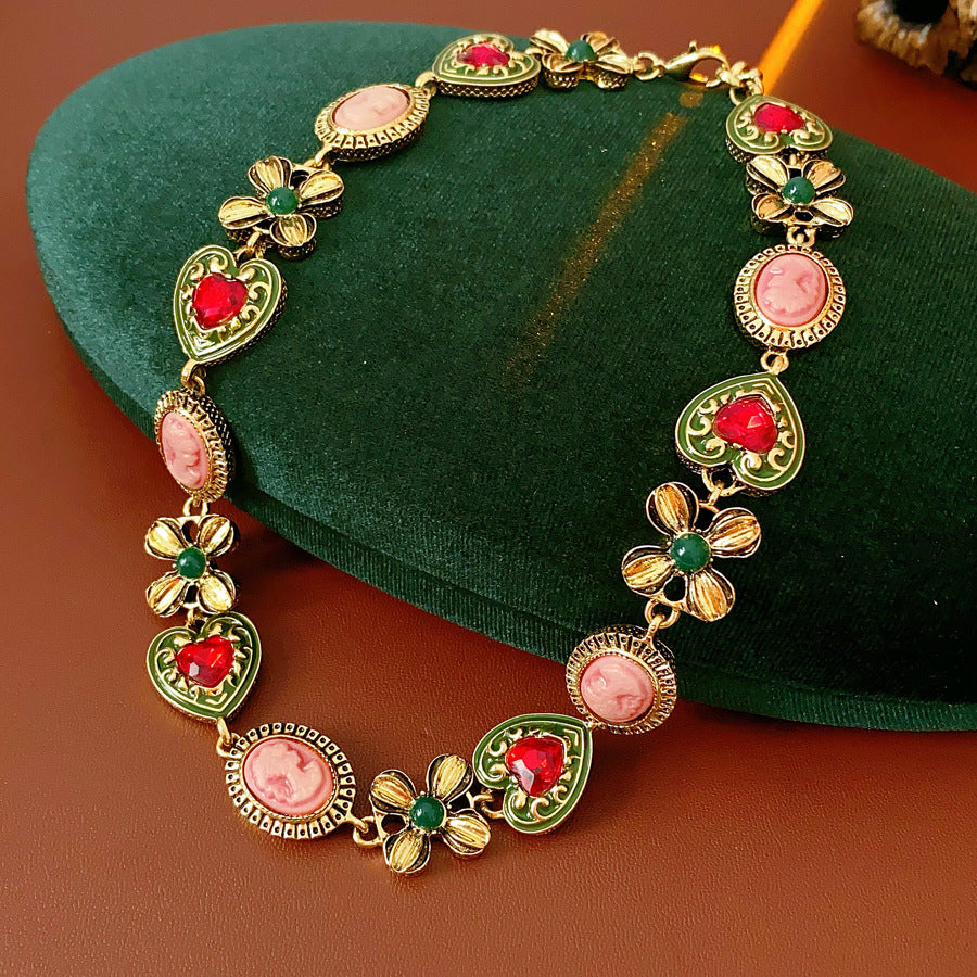 Royal Garden Cameo Set with gold-tone floral links, pink cameo ovals, green enamel hearts, and red stones