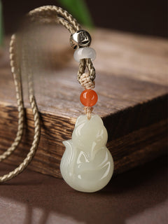 Hand-carved Hetian jade fox pendant on braided cord — Peach Blossom Hetian Jade Fox Pendant