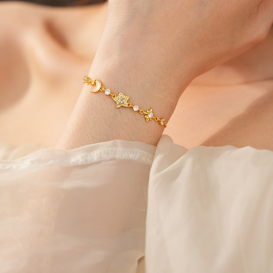 Lunar Starlight Charm Bracelet with crescent moon and star motifs on gold-tone chain – Glazenya