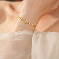 Lunar Starlight Charm Bracelet with crescent moon and star motifs on gold-tone chain – Glazenya