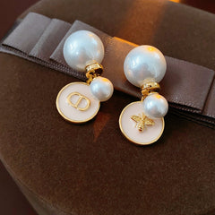 Elegant double pearl stud earrings with bee and emblem coin charms — Bee & Emblem Double Pearl Studs.