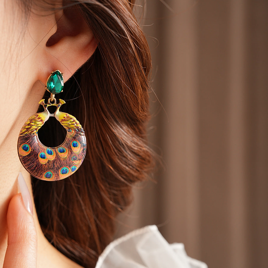 Statement earrings with peacock feather hoop design and emerald stud – Peacock Glory Statement Earrings.