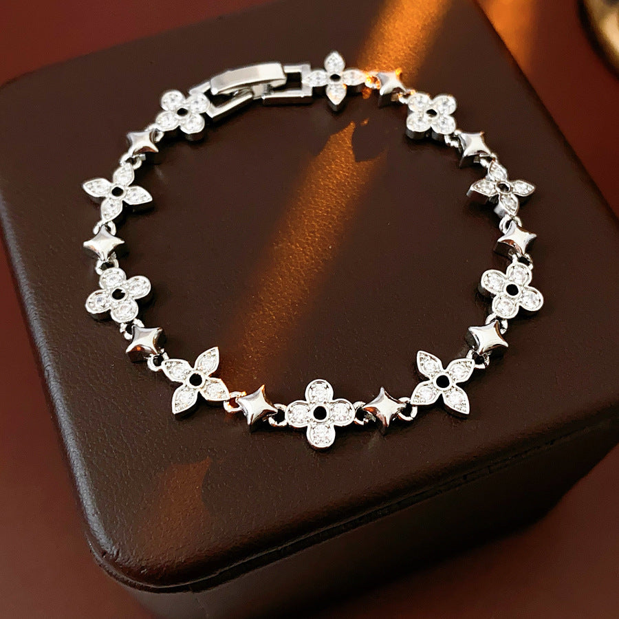 Radiant Flora Bracelet with zircon-studded floral and star motifs on dark blue box – Glazenya jewelry