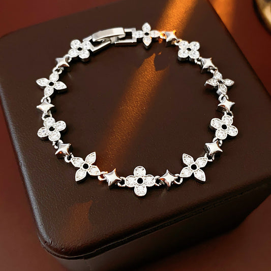 Radiant Flora Bracelet with zircon-studded floral and star motifs on dark blue box – Glazenya jewelry