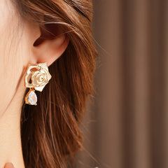Gold-tone rose stud earrings with ivory and black enamel petals plus teardrop zircon dangles — Gilded Rose Teardrop Studs.