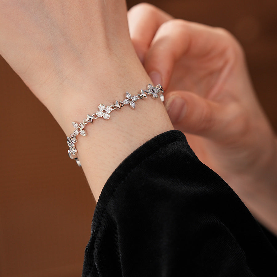 Radiant Flora Bracelet with zircon-studded floral and star motifs on dark blue box – Glazenya jewelry