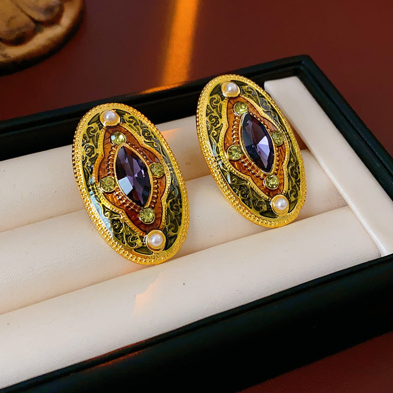 Antique-gold oval earrings with marquise purple crystal, olive rhinestones, and pearl accents — Byzantine Marquise Pearl Oval Earrings.