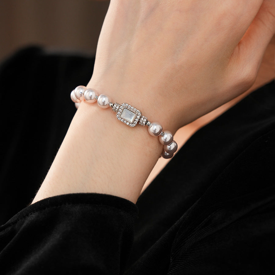 Deco Halo Pearl Bracelet featuring luminous pearls and a pavé-framed rectangular mother-of-pearl charm.