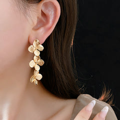 Golden Petal Elegance Set with necklace, bracelet, and earrings featuring golden floral petal details