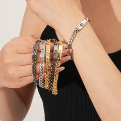 LockChain Minimalist Bracelet in silver, gold, and black metal chain with lock clasp design, displayed on wrist
