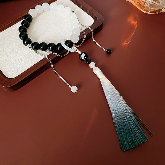 Black and white colored-glass beaded bracelet with yin-yang charm and gradient tassel — Yin-Yang Serenity Tassel Bracelet by Glazenya.