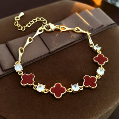 Red enamel clover bracelet with zircon accents and gold tone chain – Glazenya