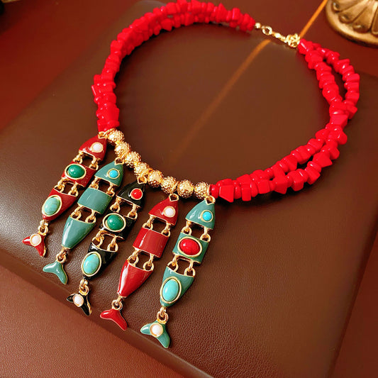 Statement necklace with articulated fishbone fringe, gold beads, and red or black chip strands — Kaleido Fishbone Fringe Necklace.