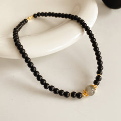 Black sandstone double-wrap bracelet with gray moonstone focal and gold accents — Midnight Moonstone Wrap Bracelet.
