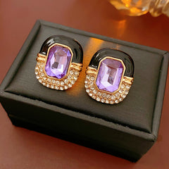 Black enamel stud earrings with amethyst-tone crystal and rhinestone frame — Midnight Amethyst Radiance Earrings.
