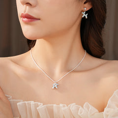 Silver-tone necklace and stud earrings with pastel blue balloon-dog charms — Blue Pup Pendant & Earrings Set.